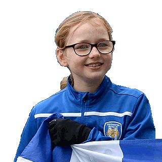 Image of a girl wearing a Colchester United tracksuit top